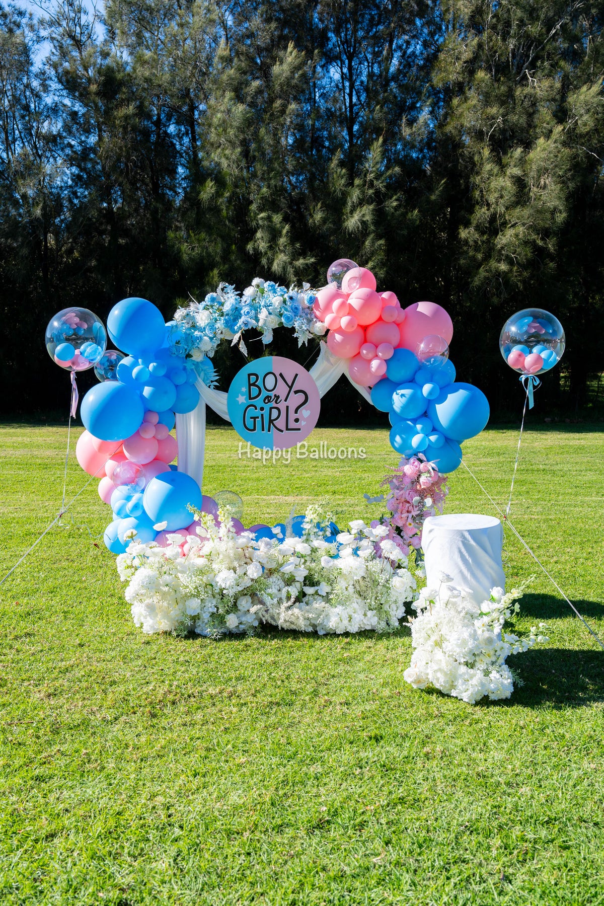 Gender reveal floral balloon ring decoration in pink and blue