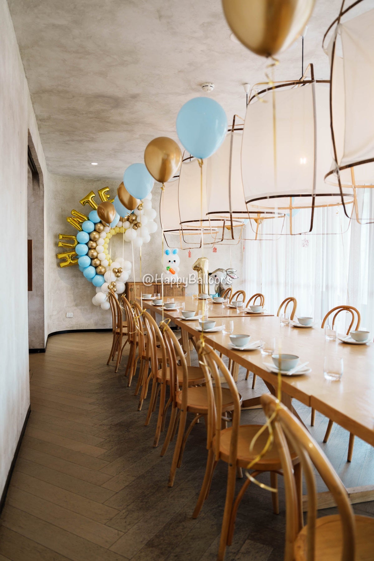 Latex and foil helium balloons floating near the ceiling at a Sydney birthday event by Happy Balloons