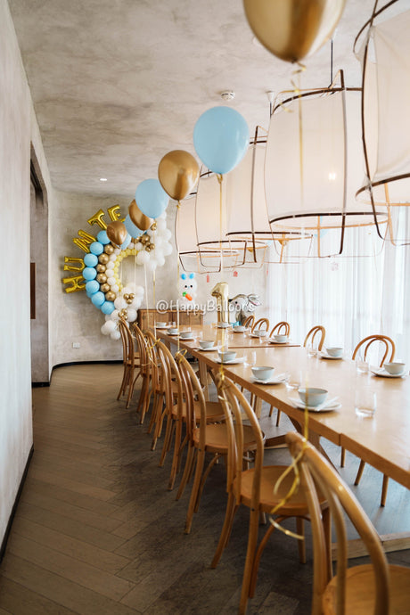 Latex and foil helium balloons floating near the ceiling at a Sydney birthday event by Happy Balloons