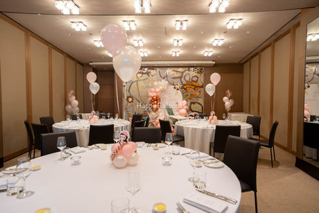 Completed penguin-themed first-birthday room with balloon backdrop and helium table centrepieces at Park Hyatt Sydney