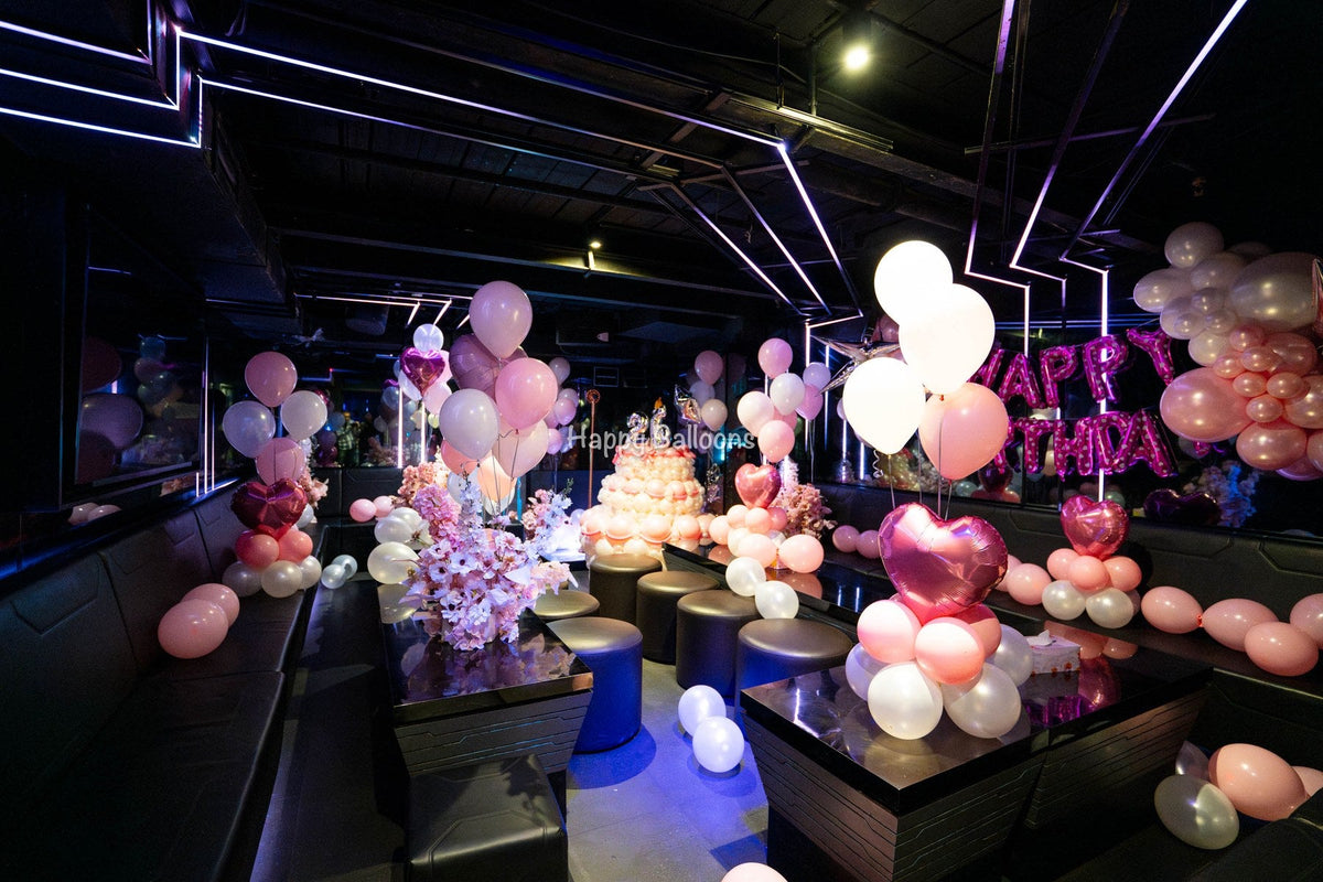 Large pink and ivory helium balloons, floral styling and a balloon cake in a Sydney KTV birthday room