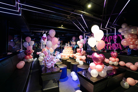 Large pink and ivory helium balloons, floral styling and a balloon cake in a Sydney KTV birthday room