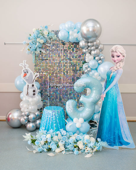 Frozen Elsa and Olaf birthday balloon setup with blue and silver decorations