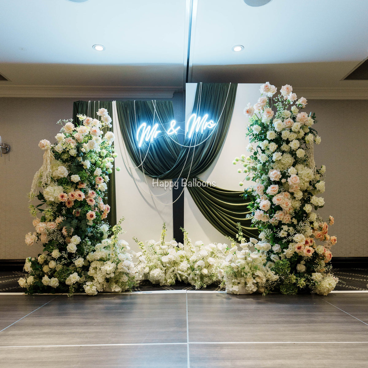 Wedding fabric backdrop with flowers balloons and warm lights