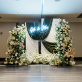 Wedding fabric backdrop with flowers balloons and warm lights