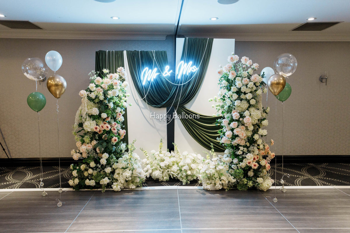 Wedding floral columns with fabric backdrop and lights