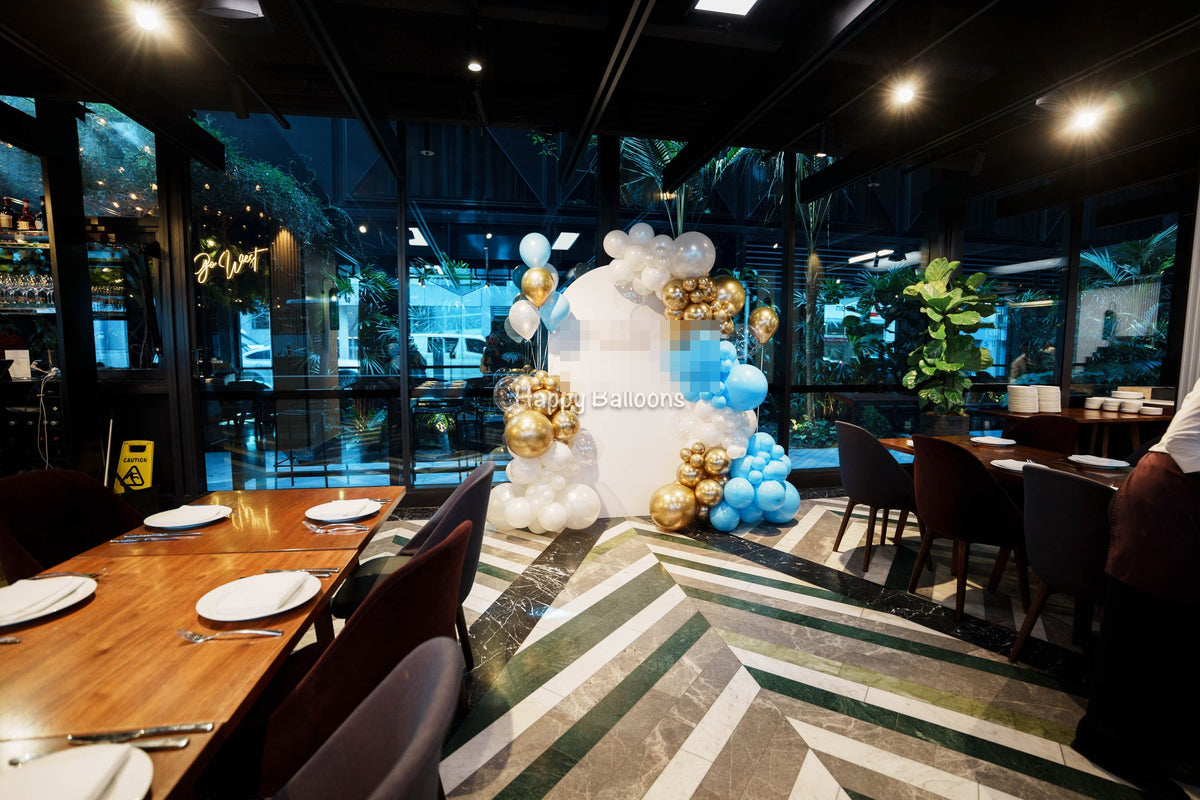 21st birthday balloon backdrop and venue setup in blue, gold and white