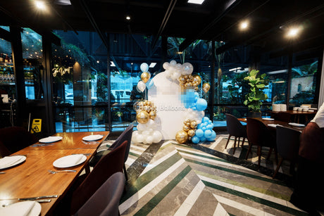 21st birthday balloon backdrop and venue setup in blue, gold and white