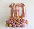 Decorative number balloon set with balloon base, flower details and bow accent